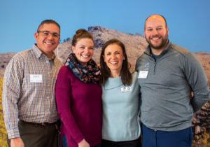 A picture of the PASCAL Center team in front of a background image of Mt. Zion.